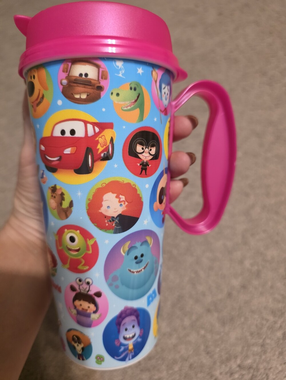 Walt Disney World Resort Pixar-themed refillable 16oz mug with a pink lid